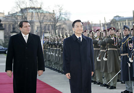 Czech Prime Minister Jiri Paroubek (L) gestures to his Chinese Prime Minister Wen Jiabao, accompanied by an unidentified Chinese military official, during the welcoming ceremony at the Czech Government headquarters upon his arrival in Prague, December 8, 2005.