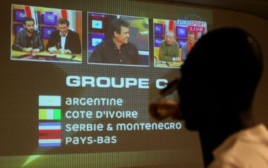 An Ivory Coast soccer fan watches the draw for the 2006 FIFA World Cup in Germany live on a screen in the country's main city of Abidjan December 9, 2005. Argentina, Ivory Coast, Serbia and Montenegro and the Netherlands were drawn in Group C for the World Cup finals in Germany.