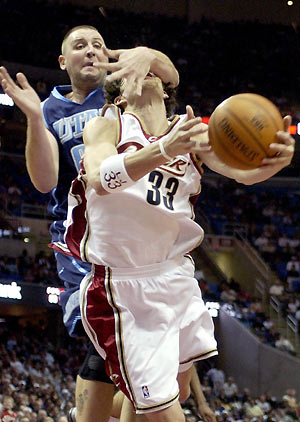 uke Jackson (33) of the Cleveland Cavaliers is fouled going to the basket by Greg Ostertag of the Utah Jazz in the fourth quarter of the NBA game at the Q in Cleveland, Ohio, December 20, 2005. Cavaliers won by 110-85. 