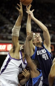 Sacramento Kings' Corliss Williamson, left, and Dallas Mavericks Dirk Nowitzki, of Germany, fight for a rebound, sandwiching Mavericks' Adrian Griffin, during the second half of the NBA basketball game Thursday, Dec. 22, 2005, in Sacramento, Calif.