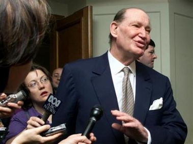 Australia's richest man Kerry Packer (R) walks past journalists at the Media and Gaming group Publishing and Broadcasting Ltd annual general meeting in Sydney in this October 31, 2001 file photo.