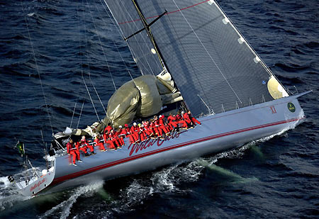 crew of Australian super-maxi Wild Oats sit on the side of the deck as they approach the finish line to take line honours for the Sydney-to-Hobart yacht race December 28, 2005.