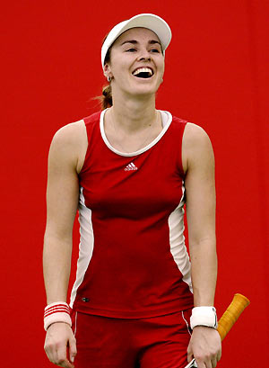 Martina Hingis laughs with her training partner at a practice session on the Gold Coast December 28, 2005. The former world number one will make her eagerly-awaited return to competitive tennis at the Australian Hardcourt Championships, which commences on January 1.