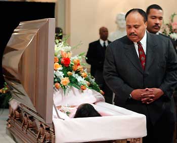 Martin Luther King III (2nd R), followed by his brother Dexter, views the body of his mother Coretta Scott King after King was taken to the State Capital to lie in honor in Atlanta February 4, 2006. The wife of civil rights leader Martin Luther King died on January 30, 2006 at the age of 78 and was the first woman and the first black person to lie in honor in Georgia. 