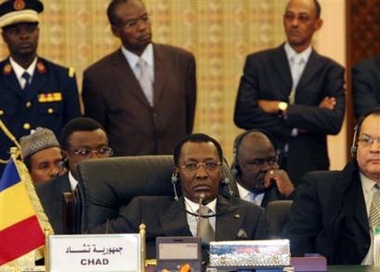 The Chad delegation, led by President Idriss Debi, center, attends an African summit ahead of signing a peace deal with Sudan, in Tripoli, Libya, late Wednesday Feb. 8, 2006. The leaders of Sudan and Chad have signed a peace agreement to end increasing tension, pledging to deny refuge to each other's rebel groups and to normalize diplomatic relations. (AP