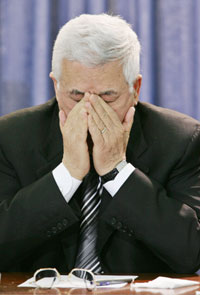 Palestinian President Mahmoud Abbas reacts during the swearing-in of the new Palestinian parliament at the Palestinian Authority headquarters in the West Bank city of Ramallah February 18, 2006. Hamas took over as the dominant party in the Palestinian parliament on Saturday and President Mahmoud Abbas challenged the militant Islamist group to recognise peace deals with Israel and maintain a truce. 