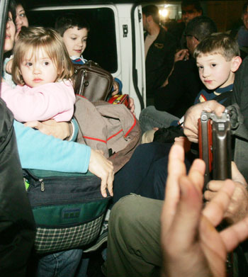 An American family is evacuated out of the Gaza Strip March 14, 2006. More than two dozen foreign aid workers and journalists took refuge inside the compound of the Palestinian Preventive Security agency in the Gaza Strip as gunmen angered by the Israeli raid scoured the territory for foreigners. 