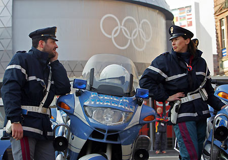 An italian policeman inspects a bus as it enters the Palavela venue for the Torino 2006 Winter Olympic Games in Turin. [Reuters]