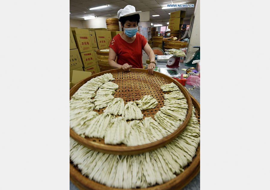 Workers make Kuanmiao noodles in SE China's Taiwan