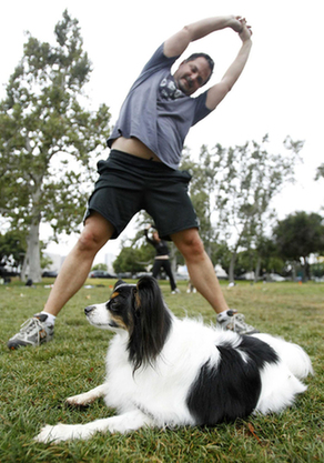 Owners work out with pets in fitness class