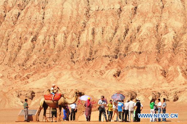 Tourists visit Flaming Mountain in Xinjiang