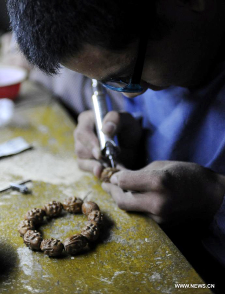 Walnut sculpture village in N China