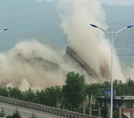 A cooling tower at the HunJiang Power Generation Company is imploded in Baishan,Northeast China's Jilin Province, July 6, 2007. China pledged to cut greenhouse gas emissions as it unveiled its first climate change action plan in early June. China has closed down small thermal power plants with total power generating capacity of 5.5 million kilowatts by now, completing 55 percent of the country's goal for this year, Xinhua reported. 