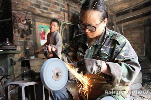 Husband-wife team work together as blacksmiths