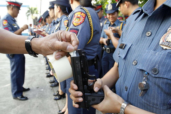 Manila police tape their guns for safety