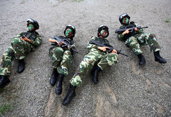 Armed policewomen train with soldiers