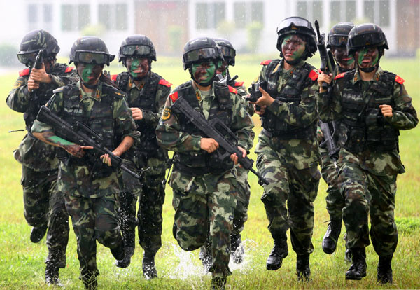 Armed policewomen train with soldiers