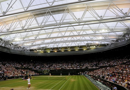 A roof closes at Wimbledon, and the fans roar