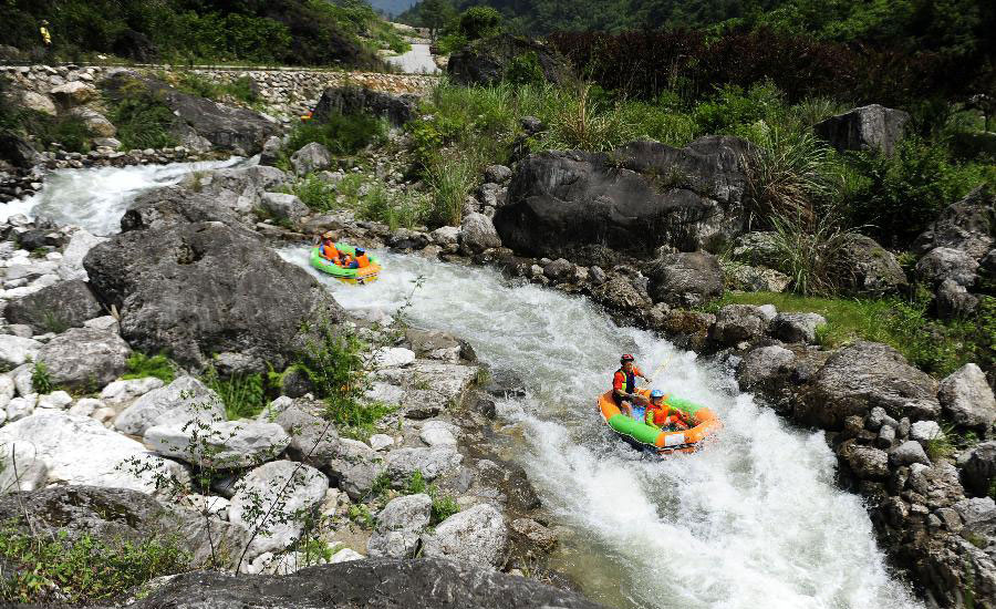 Tourists drift by rafts at China's Chaotianhou scenery spot