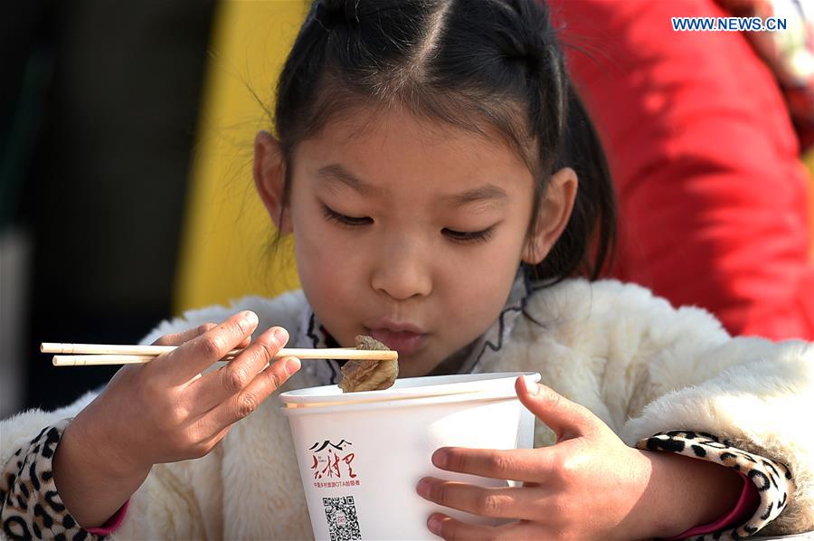 Cooks make lamb stew during food festival