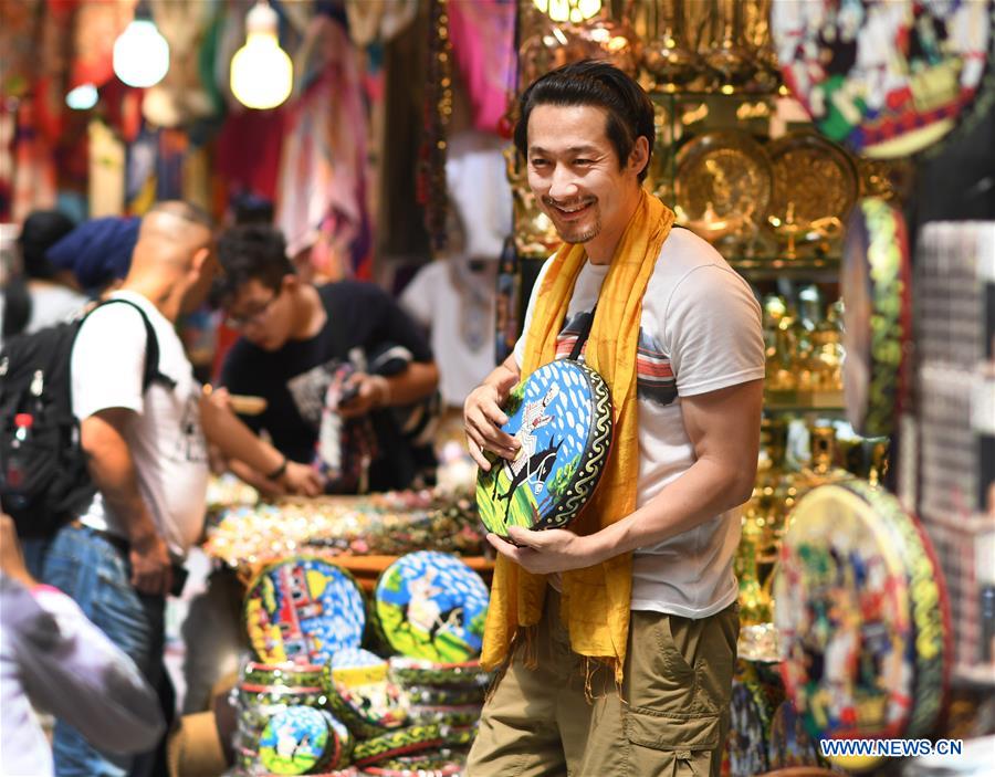 Tourists visit Int'l Bazar at Urumqi in NW China's Xinjiang