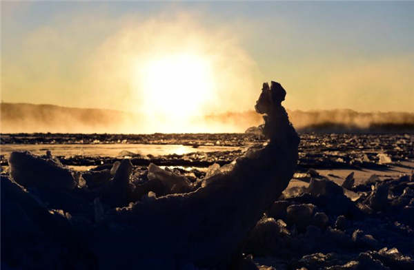 Yoga enthusiasts practice on frozen river in Heilongjiang