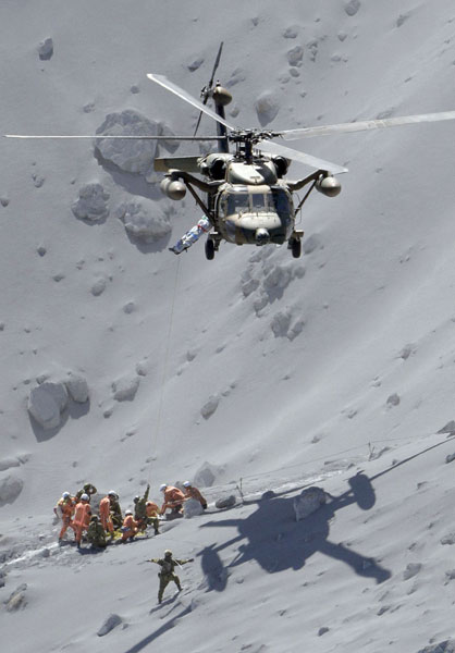 Over 30 feared dead after Japan volcano spews ash and rock